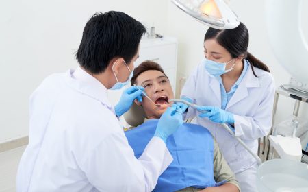 male-dentist-nurse-examining-asian-patient-s-teeth-clinic.jpg